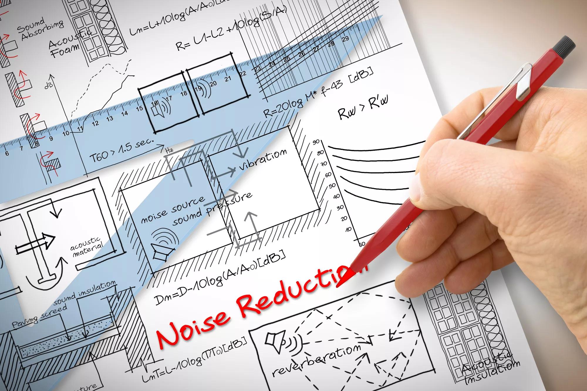 Engineer writing formulas about noise reduction in buildings - concept image.