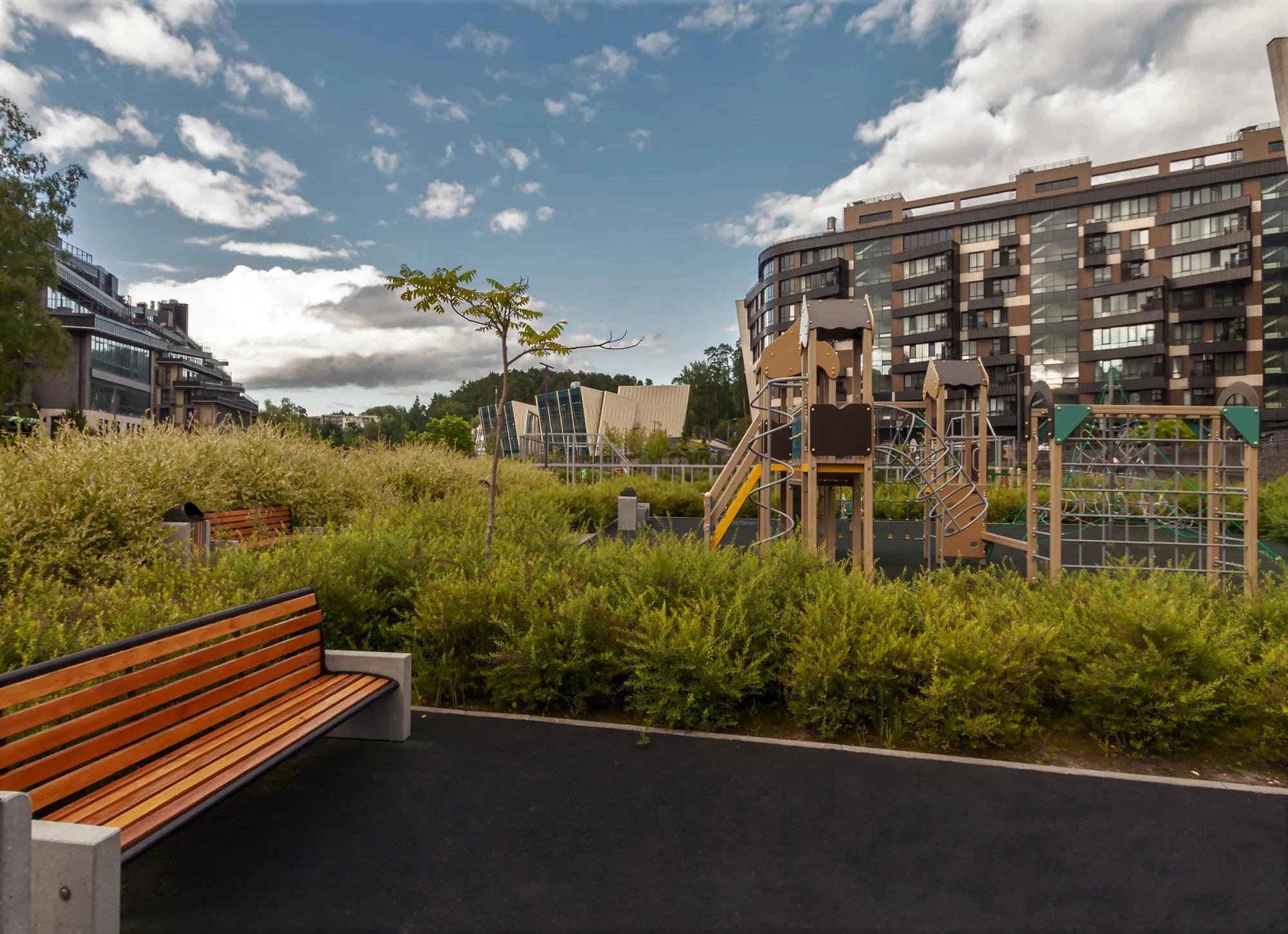 Recreation bench and children playground residential area for sale. Real estate construction building exterior and urban development concept image.