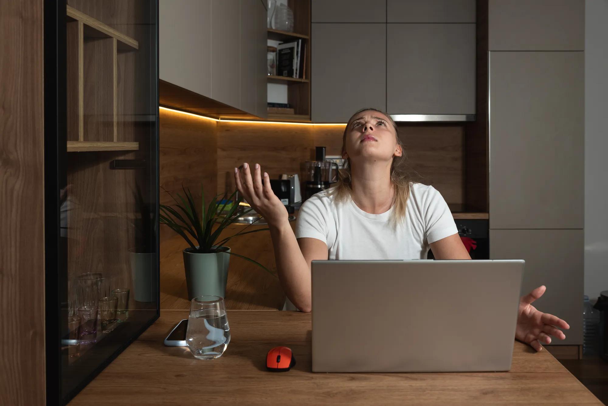 Young woman shouting trying to not to hear the loud noise from neighbor apartment in building while they renovate home and she cant work on laptop or study for school exam because of the noise