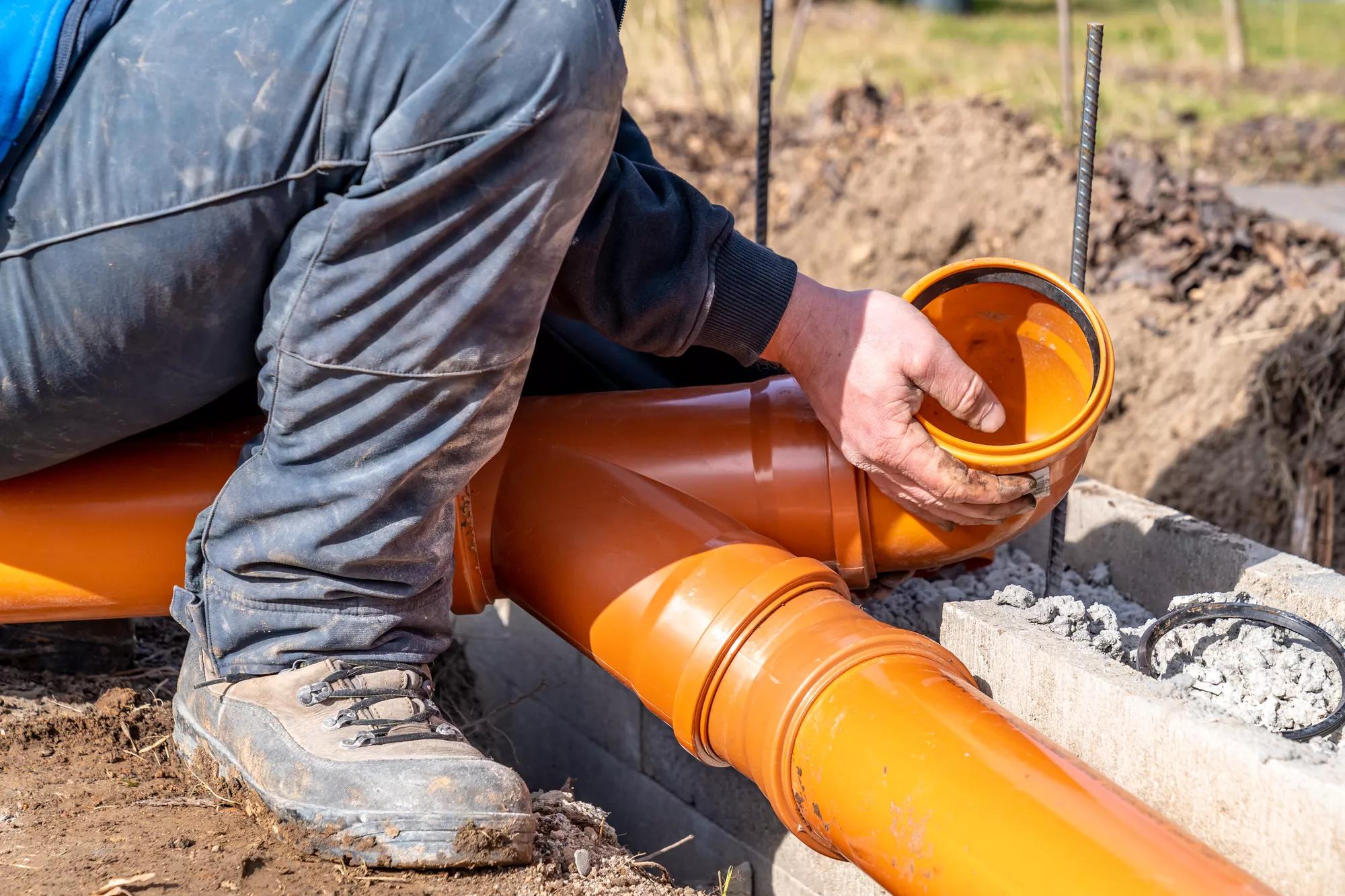 installation of a sewage plastic pipe during the construction of a house.