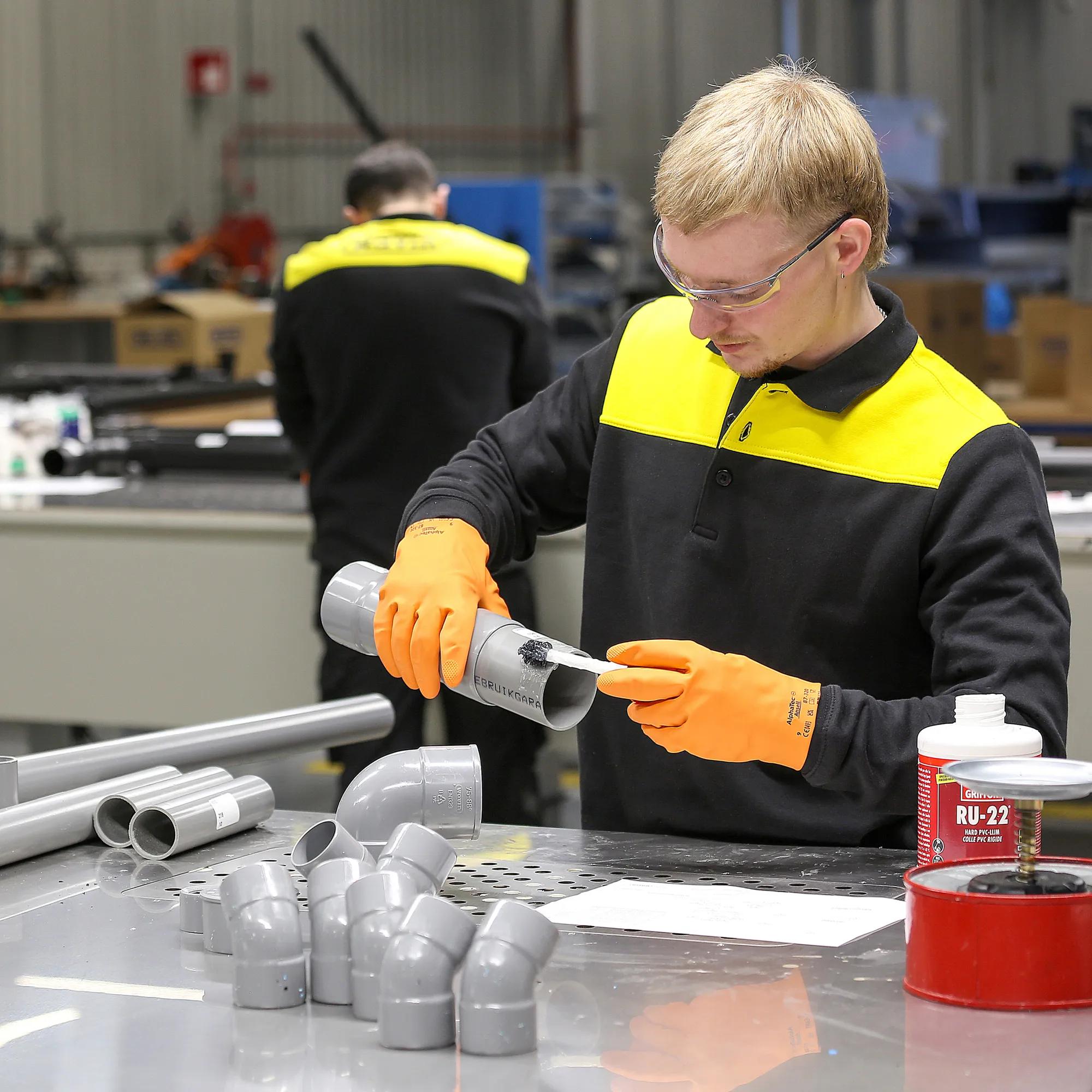 Factory employee puts together PVC pieces in the prefab department