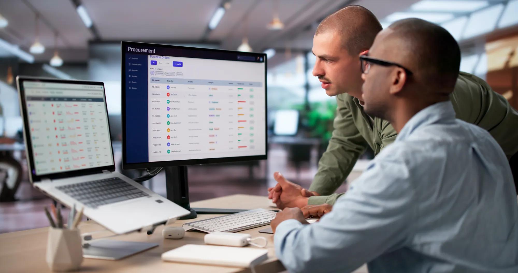 Procurement Manager And Colleague Discuss Software Platform To Improve Purchasing Decisions.