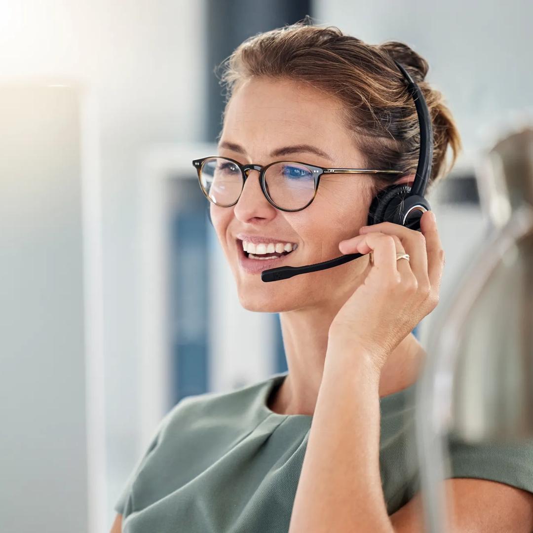 Happy call center woman consulting customer for customer support, help or telemarketing sales. Sales advisor, CRM girl with smile for success customer service, contact us hotline or insurance deal.