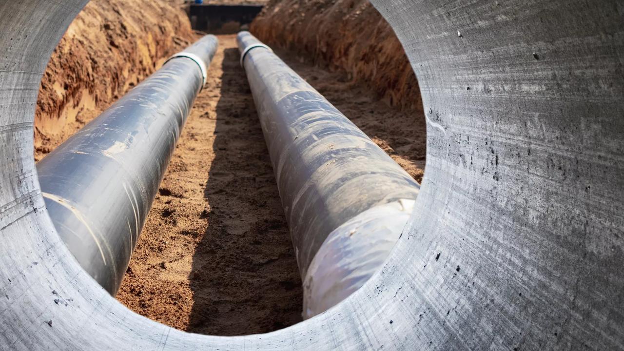 Modern water supply and sewerage system. Underground pipeline works. Water supply and wastewater disposal of a residential city. Close-up of underground utilities. View from the big pipe