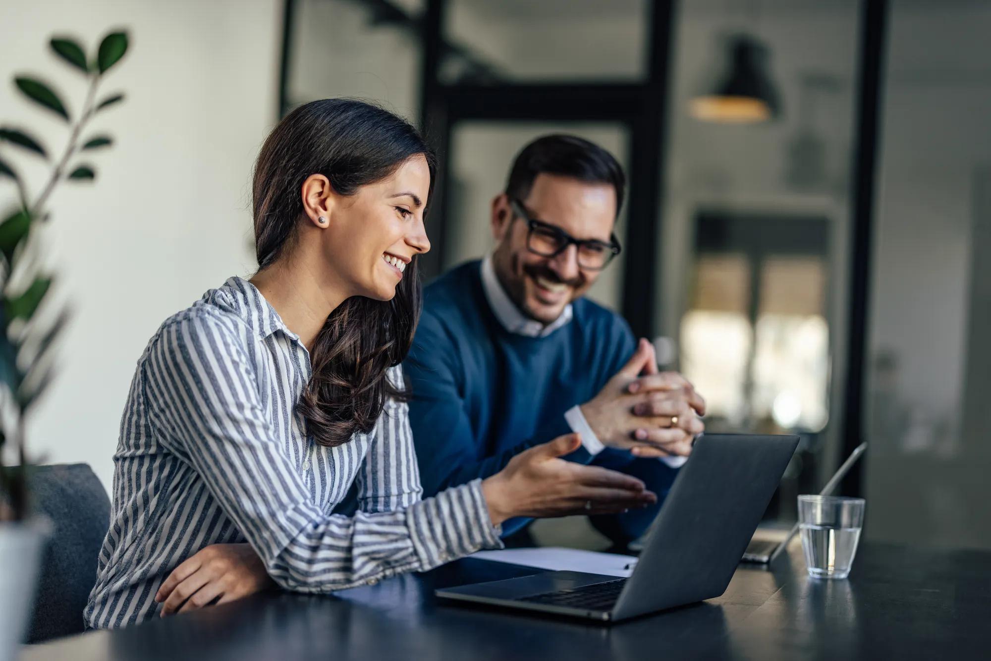 Smiling adult entrepeneurs, making sure their company is making money.