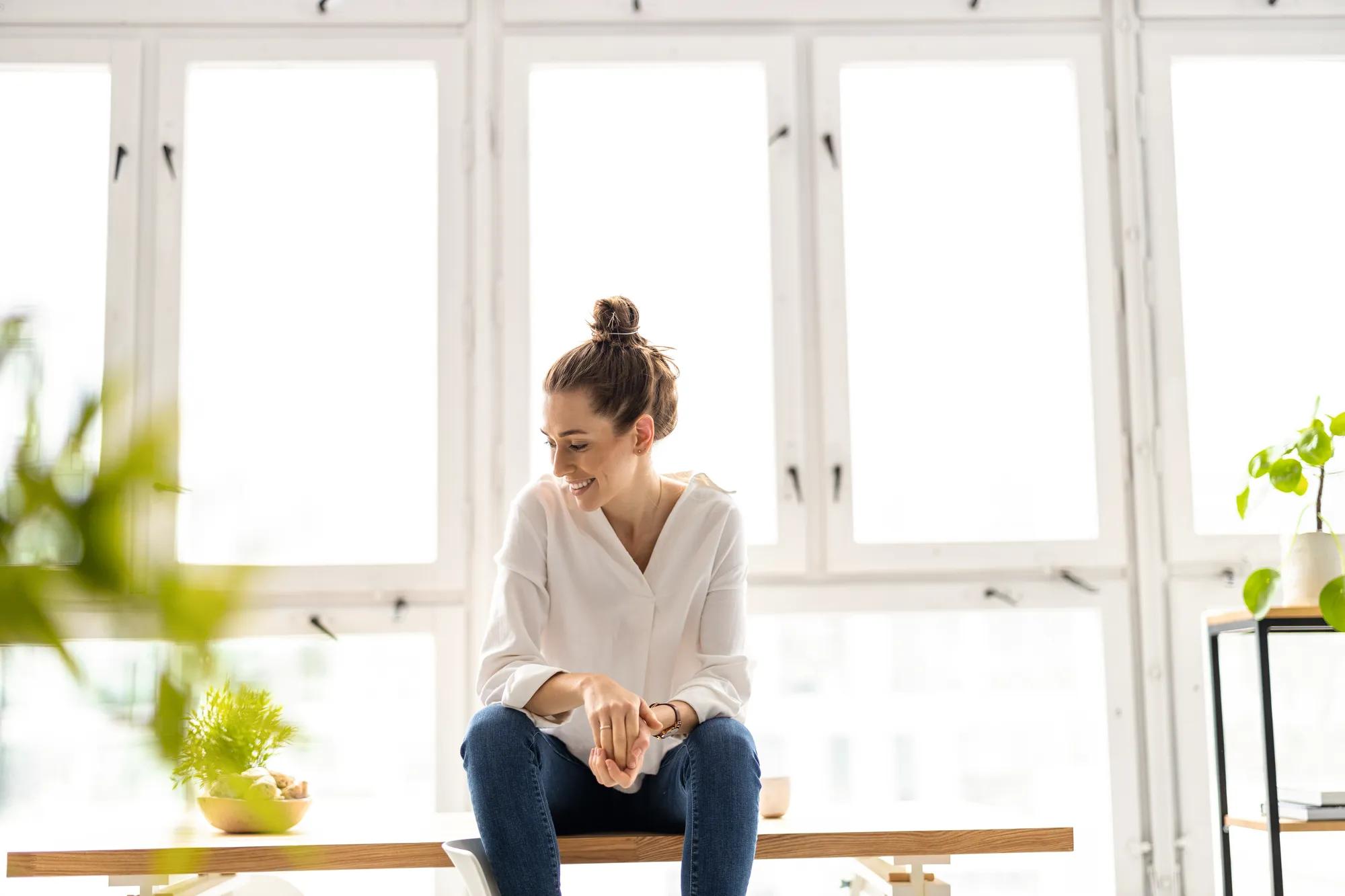 Portrait of a smiling creative woman in a modern loft space