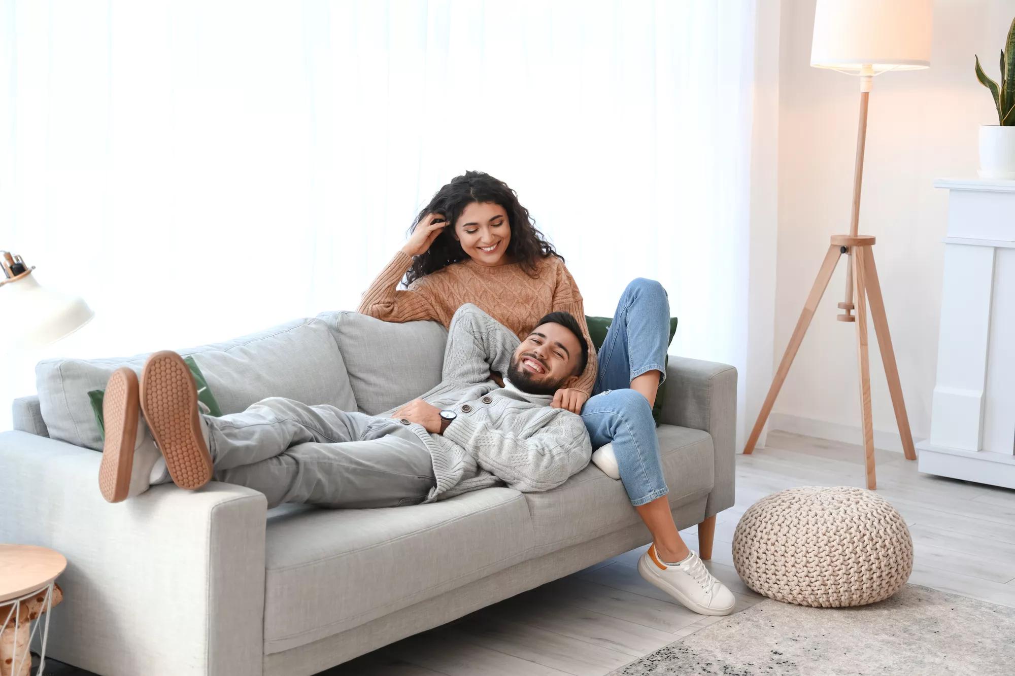 Happy young couple wearing warm sweaters at home